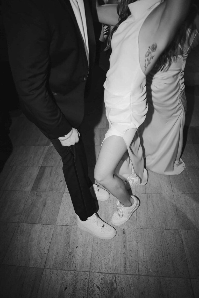 Black and white photo of a couple dancing close in custom sneakers