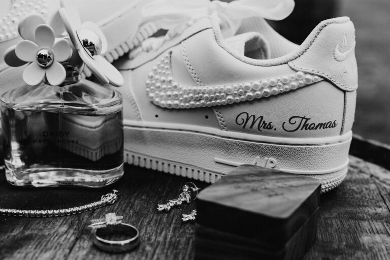 Custom "Mrs." sneakers styled with perfume, rings and jewelry
